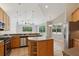 Well-lit kitchen boasts stainless steel appliances, a center island, and backyard views from the adjacent dining area at 12642 Cara Cara Loop, Bradenton, FL 34212