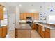Spacious kitchen with wood cabinets, an island, and stainless steel appliances at 12642 Cara Cara Loop, Bradenton, FL 34212