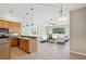 Bright living room featuring an open layout and modern kitchen with stainless steel appliances and cozy white furniture at 12642 Cara Cara Loop, Bradenton, FL 34212