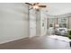 Bright living room with hardwood floors, neutral paint, and a ceiling fan, perfect for relaxation at 12642 Cara Cara Loop, Bradenton, FL 34212