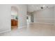 Open living space featuring neutral walls, tile flooring, and an archway leading to an adjacent room at 12642 Cara Cara Loop, Bradenton, FL 34212