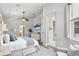 Bright primary bedroom with ensuite bathroom access, a ceiling fan, and neutral decor at 12642 Cara Cara Loop, Bradenton, FL 34212