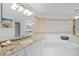 Bright bathroom with granite countertops and large bathtub at 1280 Dolphin Bay Way # 204, Sarasota, FL 34242