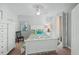 Cozy bedroom featuring a queen bed with floral bedding, shuttered windows, and neutral walls at 1280 Dolphin Bay Way # 204, Sarasota, FL 34242