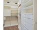 Walk in closet featuring custom shelving and drawers for organization at 1280 Dolphin Bay Way # 204, Sarasota, FL 34242