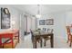 Dining area with seating for four and shutter doors to balcony and view at 1280 Dolphin Bay Way # 204, Sarasota, FL 34242