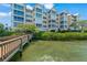 Stunning waterfront condo building with lush landscaping and private dock access for residents at 1280 Dolphin Bay Way # 204, Sarasota, FL 34242
