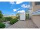 Exterior view featuring a spiral staircase, plants, pavers and waterfront access at 1280 Dolphin Bay Way # 204, Sarasota, FL 34242