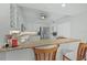 Bright kitchen with granite countertops, stainless appliances, and breakfast bar seating at 1280 Dolphin Bay Way # 204, Sarasota, FL 34242
