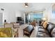 Spacious living room with tile floors, sliding glass doors, and comfortable seating at 1280 Dolphin Bay Way # 204, Sarasota, FL 34242