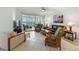 Open living room features tile floors, plenty of seating, and scenic views at 1280 Dolphin Bay Way # 204, Sarasota, FL 34242