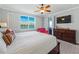 Spacious main bedroom with ceiling fan and water view from the large window at 1280 Dolphin Bay Way # 204, Sarasota, FL 34242