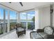 Bright sun room with serene water view, comfortable seating, and sliding doors at 1280 Dolphin Bay Way # 204, Sarasota, FL 34242