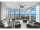 Bright sun room with serene water view, comfortable seating, and tile flooring at 1280 Dolphin Bay Way # 204, Sarasota, FL 34242