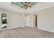 This primary bedroom has luxury vinyl flooring, tray ceiling, and multiple access doors at 144 Spring Dr, Rotonda West, FL 33947