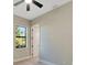 Bedroom with a ceiling fan, a window view, with a doorway leading to other areas of the home at 144 Spring Dr, Rotonda West, FL 33947