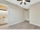 Bedroom leading to en-suite bathroom, with luxury vinyl flooring and a modern ceiling fan at 144 Spring Dr, Rotonda West, FL 33947