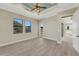 Spacious bedroom with natural light, tray ceiling, and luxury vinyl flooring at 144 Spring Dr, Rotonda West, FL 33947