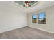 Light and airy bedroom with tray ceiling, luxury vinyl flooring and natural light from the windows at 144 Spring Dr, Rotonda West, FL 33947