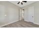Bright bedroom with plank flooring and an ensuite bathroom located down the hall at 144 Spring Dr, Rotonda West, FL 33947