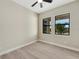 Neutral bedroom with modern plank flooring, a ceiling fan, and two large windows at 144 Spring Dr, Rotonda West, FL 33947