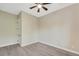 Bedroom with luxury vinyl flooring, ceiling fan, neutral paint, and a doorway at 144 Spring Dr, Rotonda West, FL 33947
