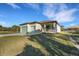 New construction with a two-car garage, neutral paint, stone accents, and a landscaped yard at 144 Spring Dr, Rotonda West, FL 33947