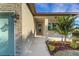 Home's front entry showcases stone accents, a tiled walkway, and well-maintained landscaping at 144 Spring Dr, Rotonda West, FL 33947