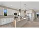 Modern kitchen with a large island, pendant lighting, stainless steel appliances, and stylish cabinetry at 144 Spring Dr, Rotonda West, FL 33947