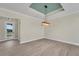 Bright, open living room features recessed lights, tile flooring, and a decorative light fixture at 144 Spring Dr, Rotonda West, FL 33947