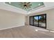Bright living room featuring tile flooring, recessed lighting, and sliding glass doors to the backyard at 144 Spring Dr, Rotonda West, FL 33947