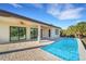 Inviting backyard oasis featuring a sparkling pool and covered patio at 144 Spring Dr, Rotonda West, FL 33947