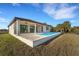 Stunning home exterior with a pristine pool and meticulously maintained lawn at 144 Spring Dr, Rotonda West, FL 33947