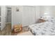 Cozy bedroom features wood-look floors, starfish themed decor, closet and en-suite bathroom for convenience at 157 Pinehurst Dr # 157, Bradenton, FL 34210