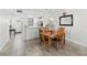 Cozy dining area with wood table, seating for four, and decorative mirror at 157 Pinehurst Dr # 157, Bradenton, FL 34210