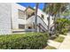 Exterior view of a two-story condo building with lush tropical landscaping surrounding a private community at 157 Pinehurst Dr # 157, Bradenton, FL 34210