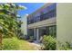 Exterior view of a condo building with lush landscaping, a well-manicured lawn, and beautiful tropical foliage at 157 Pinehurst Dr # 157, Bradenton, FL 34210