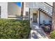 Inviting condo entrance with charming garden and brick pathway leading to a neutral-colored front door at 157 Pinehurst Dr # 157, Bradenton, FL 34210