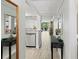 Hallway view featuring a stainless steel dishwasher and decorative mirrors at 157 Pinehurst Dr # 157, Bradenton, FL 34210