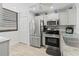 Well-lit kitchen with stainless steel refrigerator, range, and oven with ample cabinet space at 157 Pinehurst Dr # 157, Bradenton, FL 34210