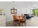 Open-concept living space with dining table, sitting area, and sliding glass doors to the lanai at 157 Pinehurst Dr # 157, Bradenton, FL 34210
