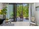 Covered patio features comfortable seating and views of the lush tropical garden beyond at 157 Pinehurst Dr # 157, Bradenton, FL 34210
