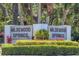 View of the 'Wildewood Springs' community sign, nestled amongst manicured landscaping and foliage at 157 Pinehurst Dr # 157, Bradenton, FL 34210