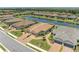 Aerial view of a home with a beautiful tile roof, nicely landscaped and located by a lake at 15707 Sacile Ln, Bradenton, FL 34211