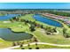 Aerial view of a community golf course with multiple ponds and beautifully landscaped greens at 15707 Sacile Ln, Bradenton, FL 34211