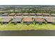Aerial view showcasing homes with tile roofs, backyard pools, and lake views at 15707 Sacile Ln, Bradenton, FL 34211