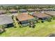 Aerial view of a home with a private pool and screened lanai in a residential neighborhood at 15707 Sacile Ln, Bradenton, FL 34211