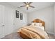 Bedroom with a wicker bed frame, complemented by a ceiling fan, art, and plenty of natural light at 15707 Sacile Ln, Bradenton, FL 34211
