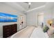 Bedroom featuring a TV, ceiling fan, and ensuite bathroom at 15707 Sacile Ln, Bradenton, FL 34211