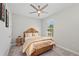 Relaxing bedroom with a natural-toned bed, a ceiling fan, and a window providing natural light and views at 15707 Sacile Ln, Bradenton, FL 34211